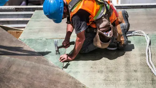 Professional deck builders in New Jersey installing a custom wooden deck for a residential outdoor living space