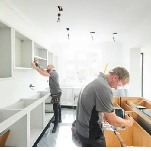 Professional contractors installing custom kitchen cabinets during a home remodeling project in New Jersey