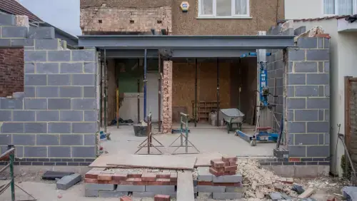 Expert NJ exterior renovation services showing a residential home extension and outdoor construction site