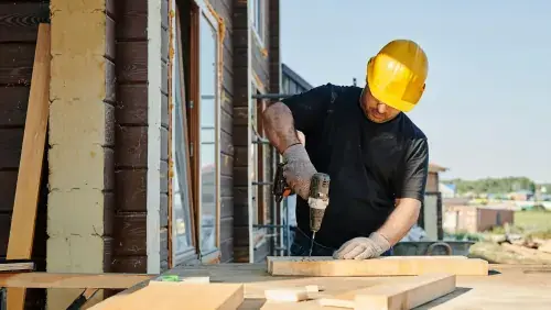 Professional NJ roofer working on a residential construction project with safety gear and power tools