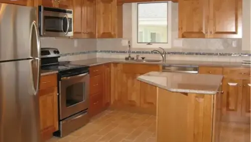 Professional kitchen renovation services in NJ by Tedesco Remodeling showing a completed kitchen project with wood cabinets and granite countertops